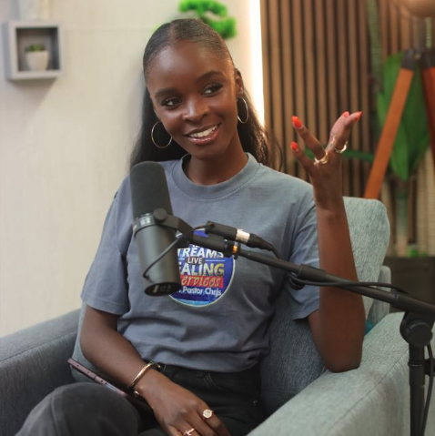 A smiling woman taking part in a conversation at a microphone