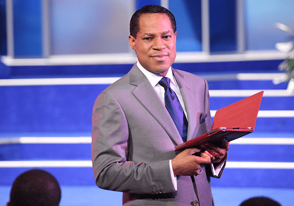 Pastor Chris Oyakhilome teaching with an open Bible